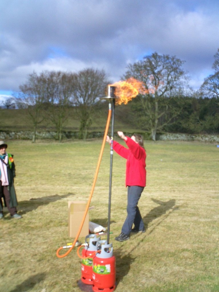 Woman lighting gas flame